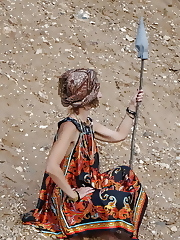 With spear wearing in colorful dress